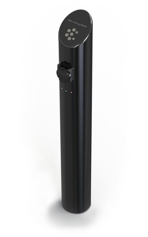 A slim black metal bollard standing on the ground. The socket for an EV charging cable is near the top of the bollard.